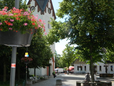 Auch entlang der Kirchenstraße sorgen die Blumenampeln für ein farbenfrohes Erscheinungsbild der Innenstadt.  Foto: Bosse